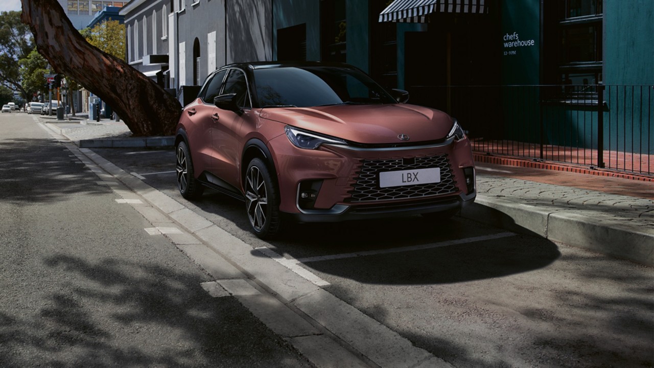 Een Lexus LBX geparkeerd naast een gebouw