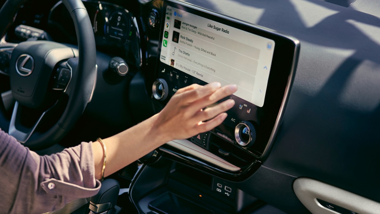 A person interacting with a Lexus multimedia display