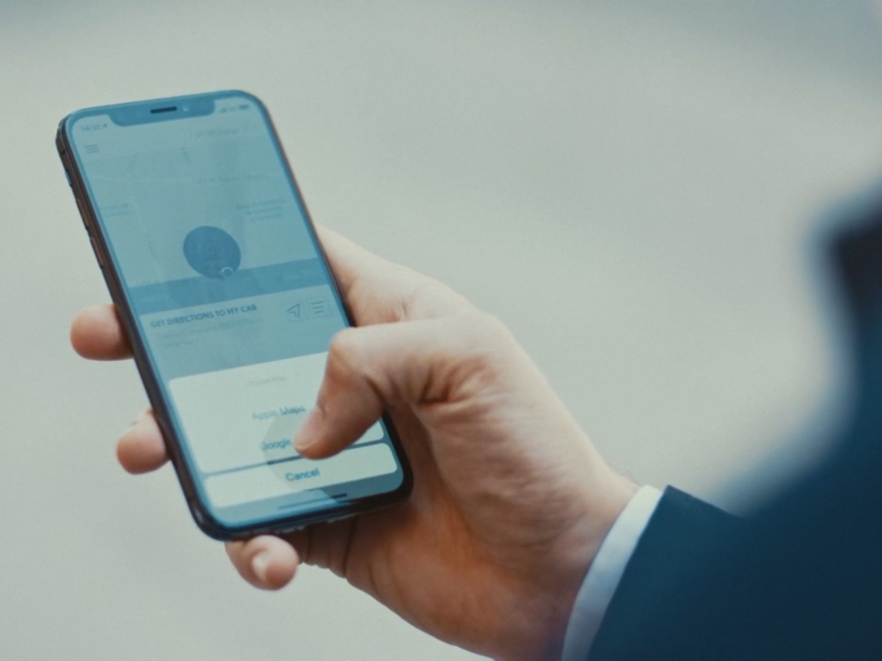 Een persoon die een mobiele telefoon gebruikt om toegang te krijgen tot de Lexus Link app